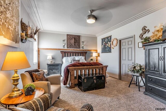 bedroom with ceiling fan, ornamental molding, and carpet flooring