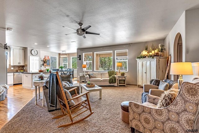 carpeted living room featuring ceiling fan