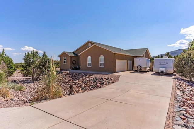 view of side of property featuring a mountain view and a garage