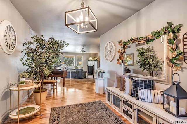 interior space with an inviting chandelier and light hardwood / wood-style flooring