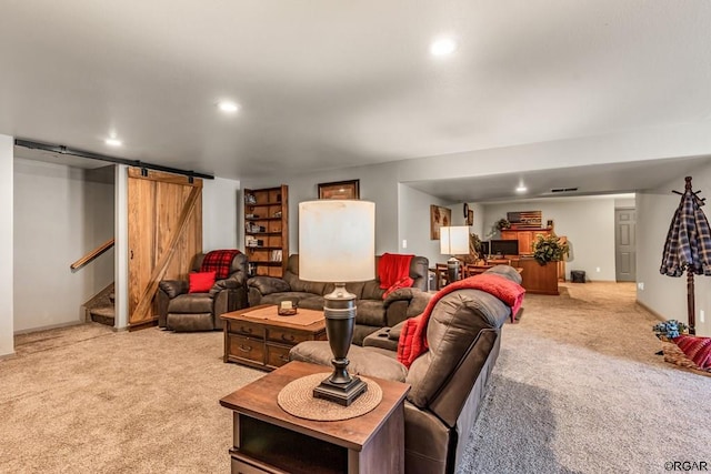 living room featuring a barn door and light carpet