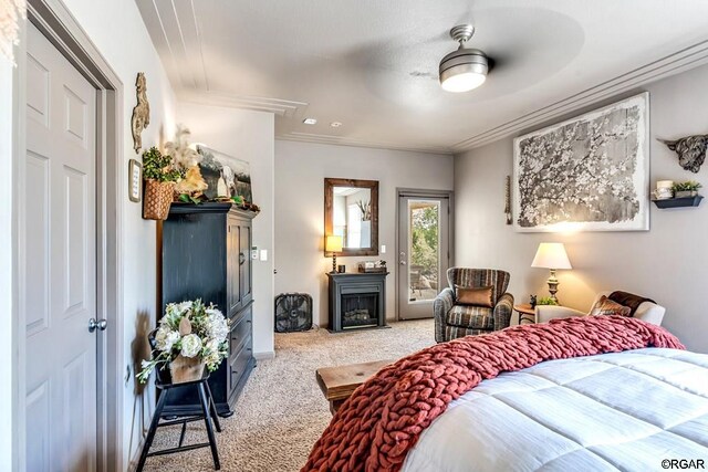 carpeted bedroom with ornamental molding, access to exterior, and ceiling fan