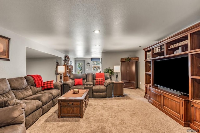 carpeted living room featuring a textured ceiling