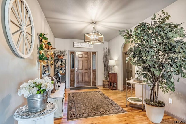 foyer featuring a notable chandelier and light wood-type flooring