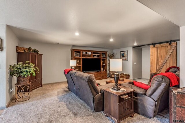 carpeted living room featuring a barn door