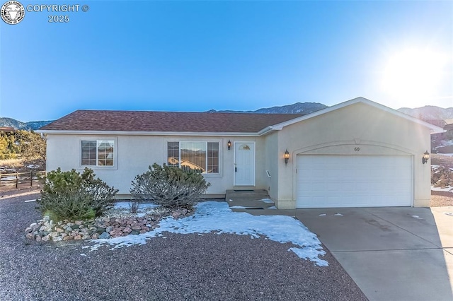 single story home featuring a garage and a mountain view