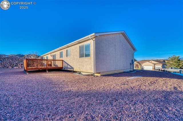 rear view of house featuring a deck