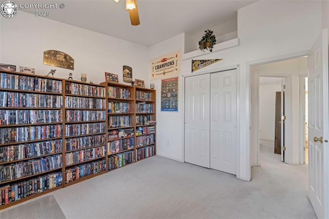 interior space with light carpet and ceiling fan