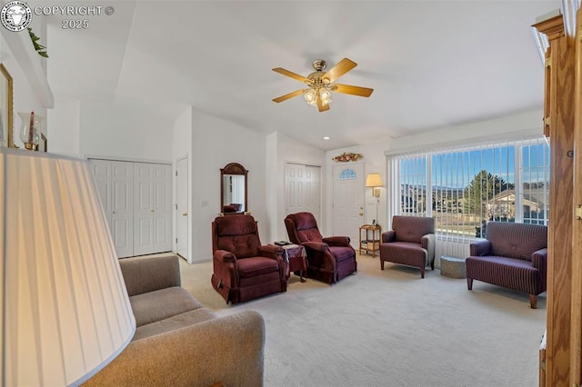 carpeted living room with lofted ceiling and ceiling fan