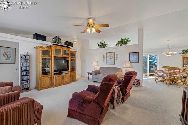 carpeted living room with ceiling fan with notable chandelier