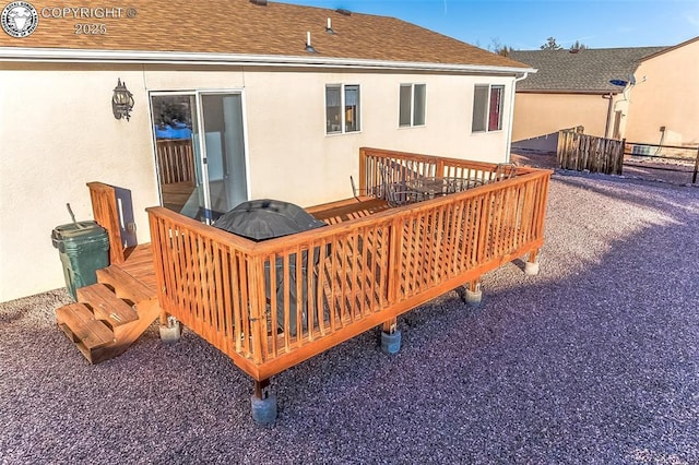 rear view of house featuring a wooden deck