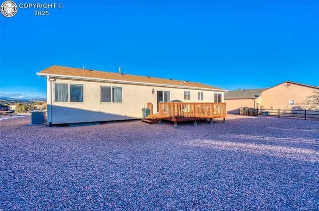 rear view of property with central AC and a deck