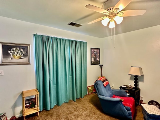 sitting room with carpet flooring and ceiling fan