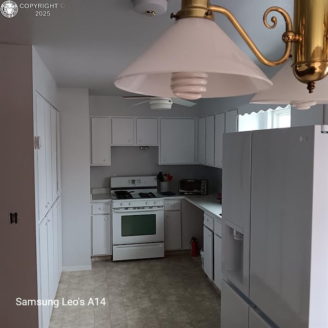 kitchen featuring white cabinetry, ceiling fan, and white appliances