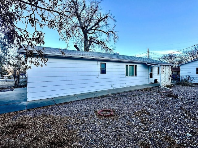 view of property exterior with a patio