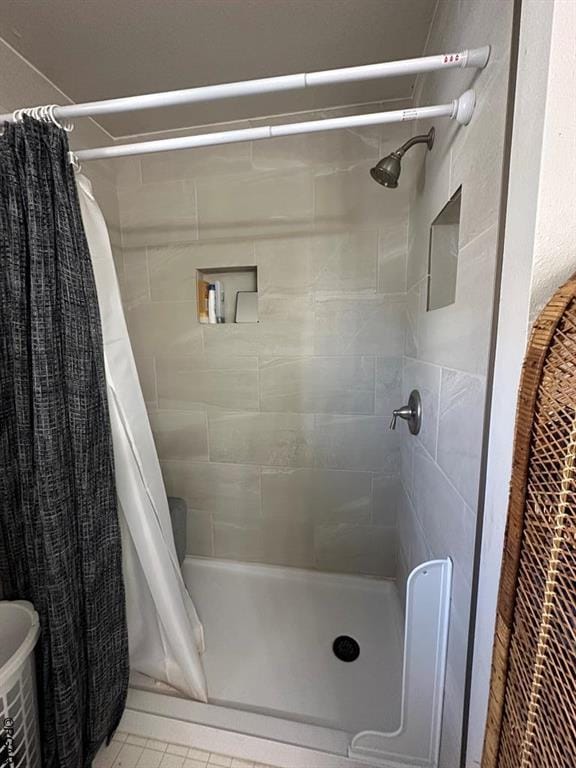 bathroom with a shower with curtain and tile patterned floors