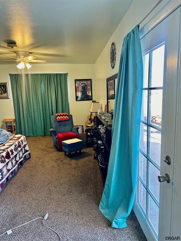 carpeted bedroom featuring ceiling fan