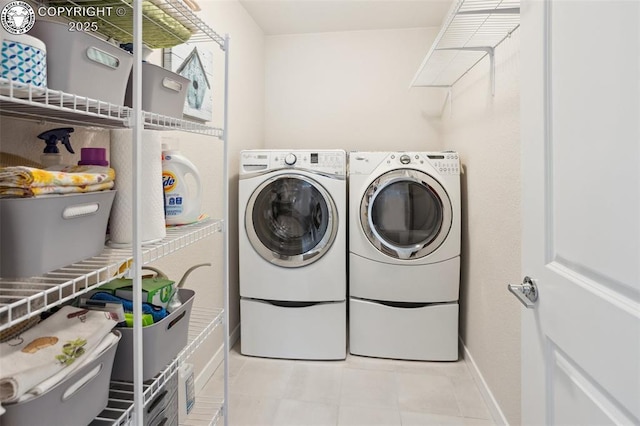 16840 New Autumn Dr, Monument, CO 80132 - laundry room featuring washer and clothes dryer, baseboards, and light tile patterned floors