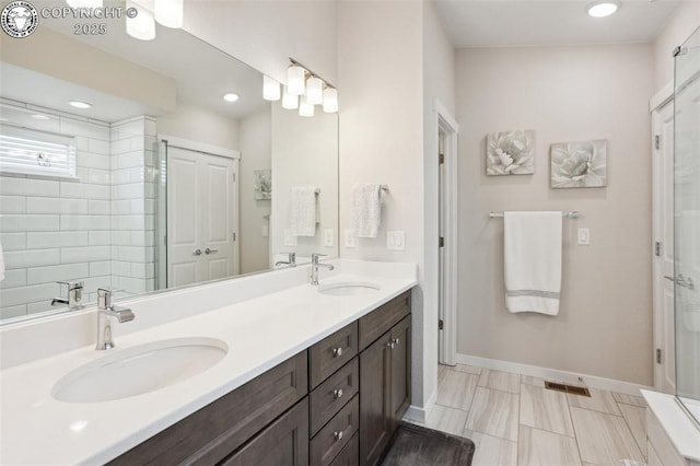 16840 New Autumn Dr, Monument, CO 80132 - bathroom with double vanity, baseboards, recessed lighting, and an enclosed shower