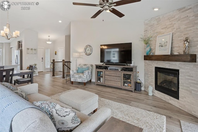 16840 New Autumn Dr, Monument, CO 80132 - living room with a ceiling fan, a chandelier, wood finished floors, a fireplace, and recessed lighting