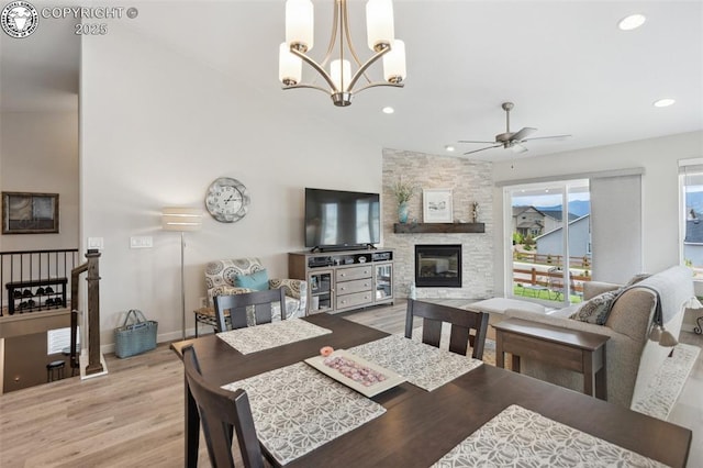 16840 New Autumn Dr, Monument, CO 80132 - dining area with ceiling fan, light wood-type flooring, a stone fireplace, a chandelier, and recessed lighting