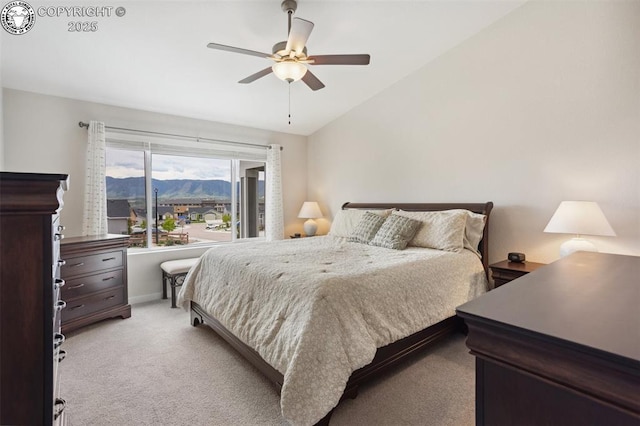 16840 New Autumn Dr, Monument, CO 80132 - bedroom featuring vaulted ceiling, light colored carpet, a mountain view, and a ceiling fan