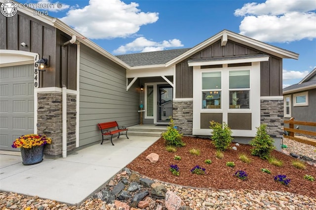 16840 New Autumn Dr, Monument, CO 80132 - view of front facade with a garage, stone siding, and board and batten siding