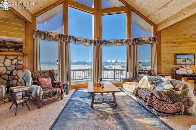 carpeted living room with wooden ceiling, wood walls, high vaulted ceiling, and beam ceiling