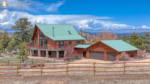 cabin featuring fence private yard, stairs, a deck with mountain view, and log exterior