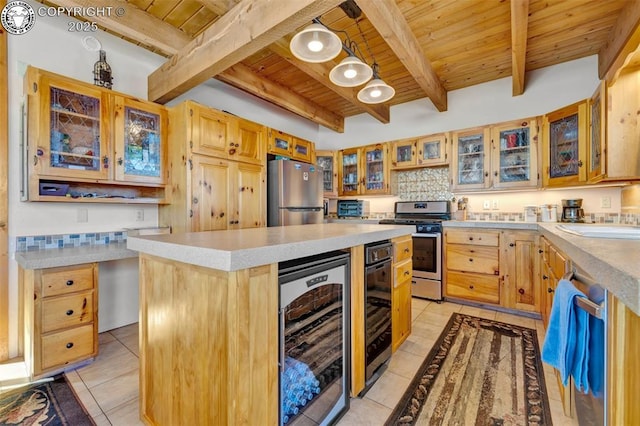 kitchen with beverage cooler, appliances with stainless steel finishes, beam ceiling, and wood ceiling