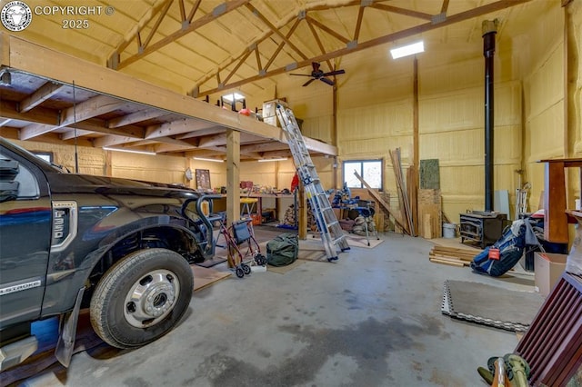 garage featuring a ceiling fan and a wood stove