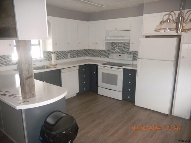 kitchen featuring dark wood-type flooring, white cabinetry, pendant lighting, white appliances, and range hood