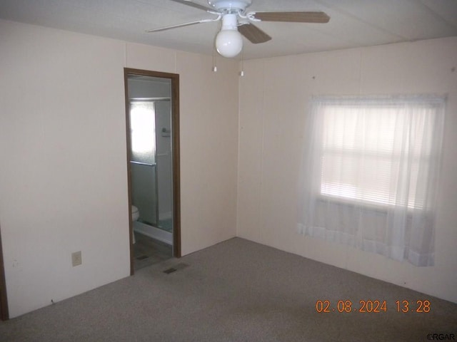 carpeted spare room with ceiling fan