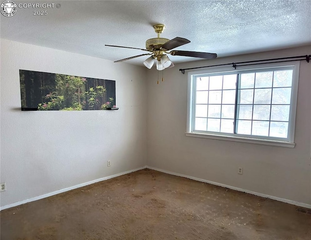 empty room featuring ceiling fan and a textured ceiling