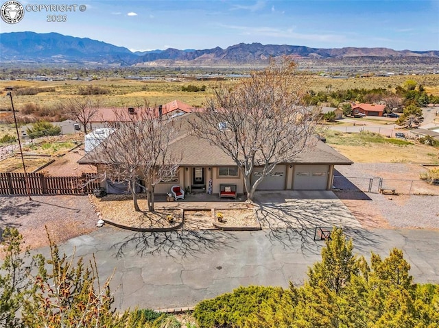 3082 High St, Canon City, CO 81212 - view of front of home featuring a mountain view, driveway, a garage, and fence private yard