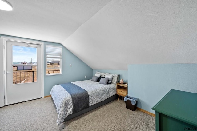 bedroom with vaulted ceiling and carpet flooring