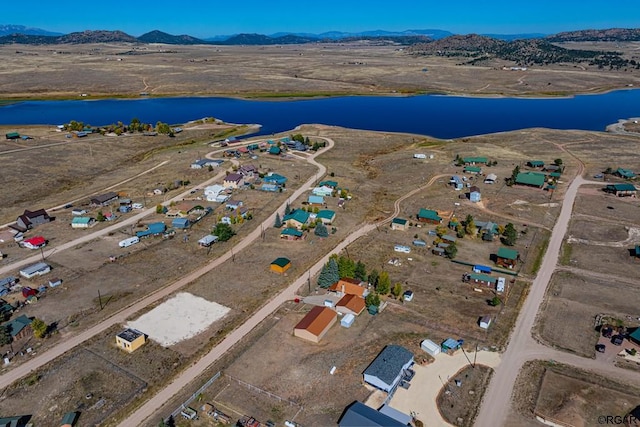 aerial view featuring a water and mountain view