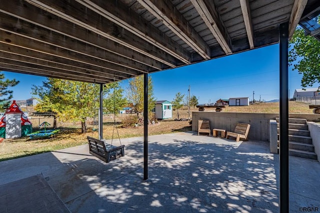 view of patio with a storage unit