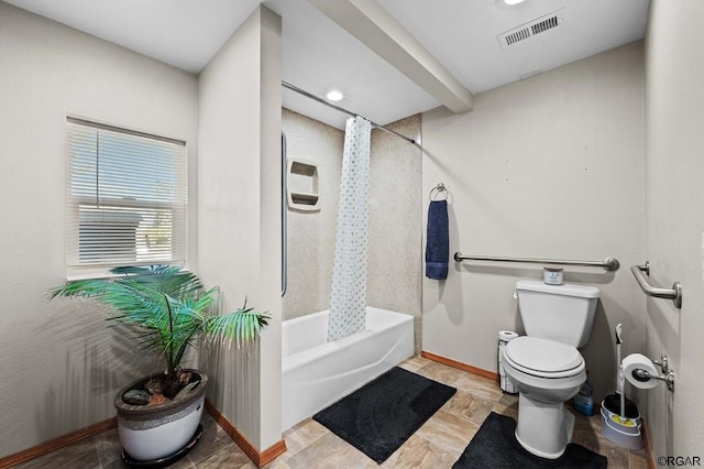 bathroom featuring toilet and shower / bath combo with shower curtain