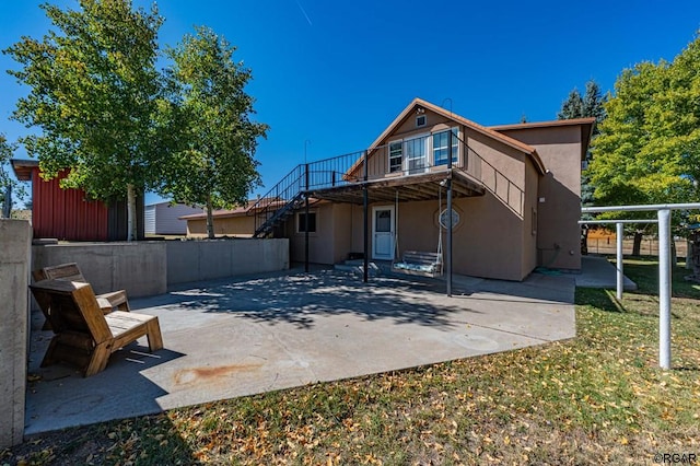 rear view of property featuring a patio