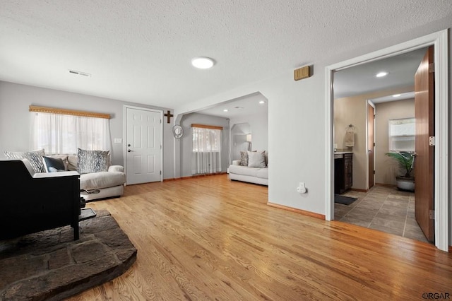 living room with hardwood / wood-style floors and a textured ceiling