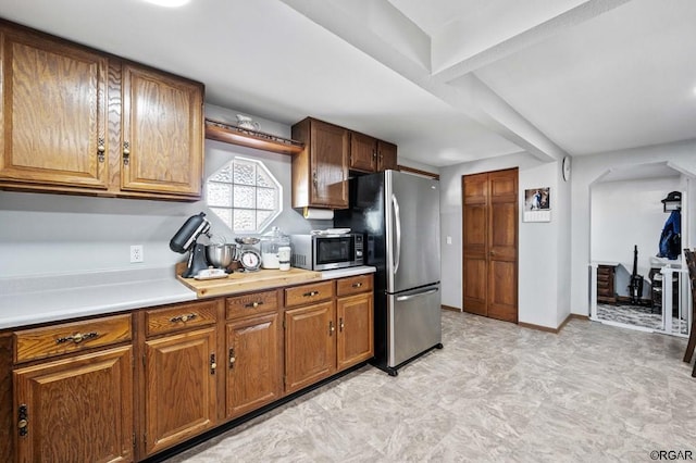 kitchen with beamed ceiling and appliances with stainless steel finishes