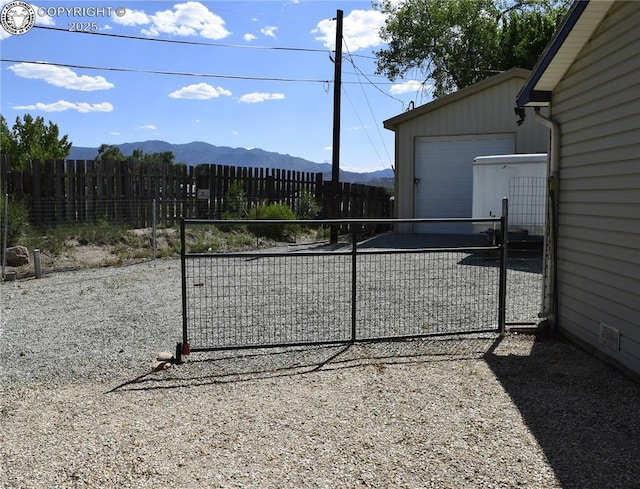 113 Rio Grande Dr, Canon City, CO 81212 - view of yard with a mountain view, a garage, an outdoor structure, and a gate