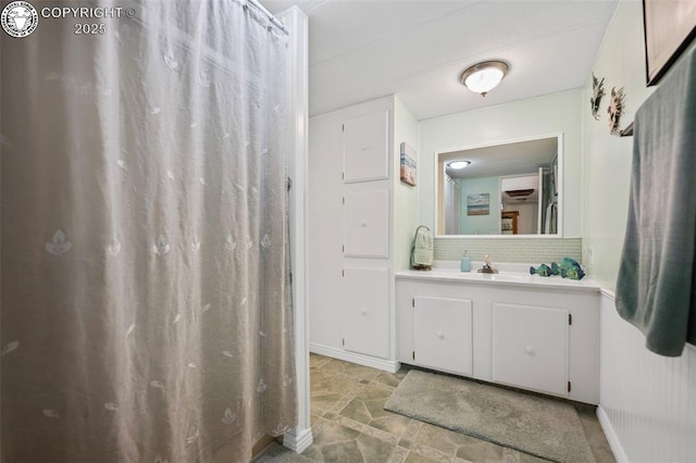 bathroom with tasteful backsplash and vanity