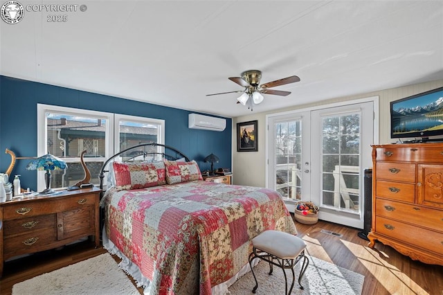 bedroom featuring ceiling fan, access to outside, multiple windows, and an AC wall unit