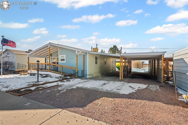 rear view of property featuring a carport