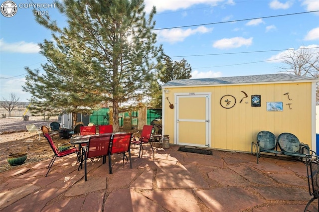 view of patio featuring a shed