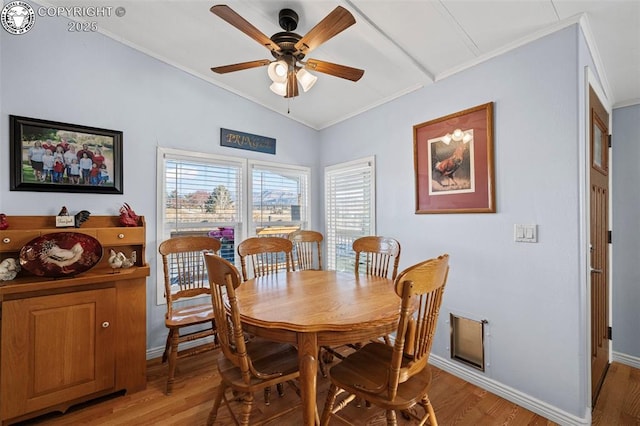 dining area with ceiling fan, lofted ceiling, crown molding, and light hardwood / wood-style floors