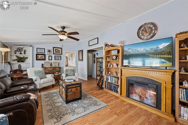 living room featuring hardwood / wood-style flooring and ceiling fan