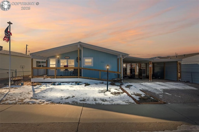 view of front of house featuring a carport and covered porch